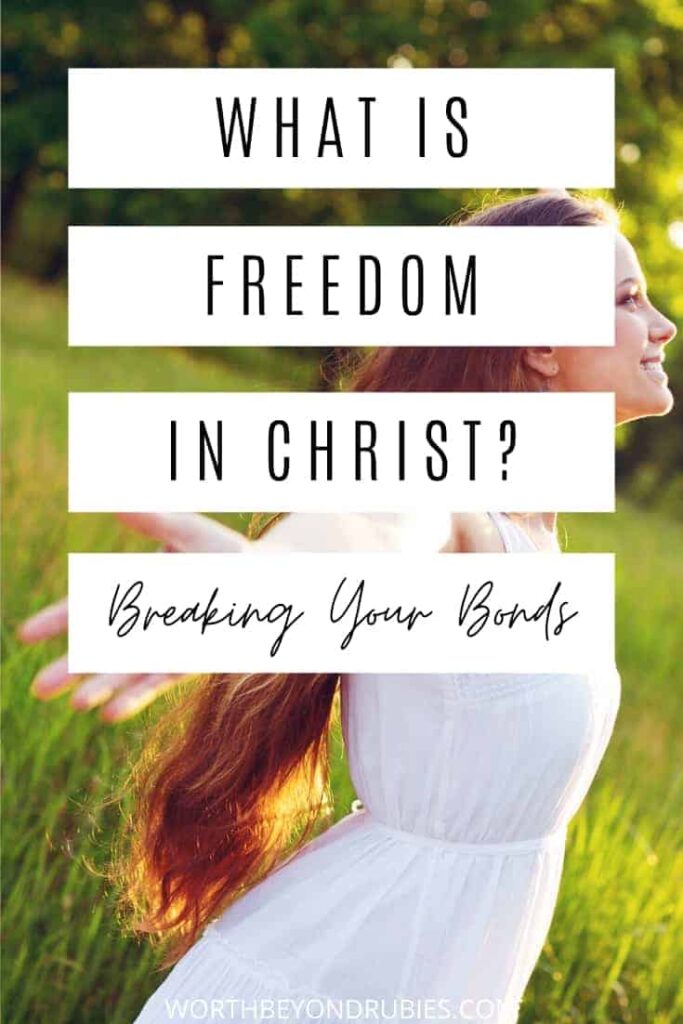 a woman in a field with her face toward heaven and her arms out to her side and a text overlay that says What is Freedom in Christ?