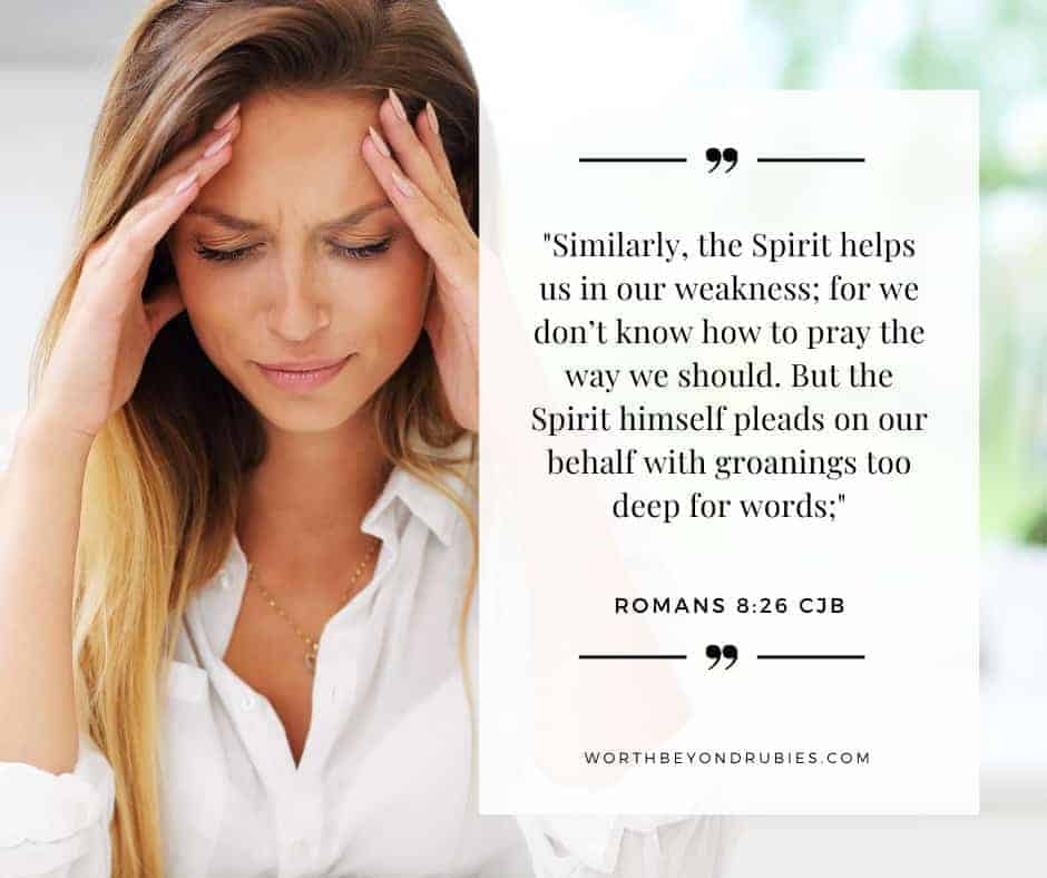 An image of a white woman with long blonde hair looking sad, sitting at a table with her fingers placed on her forehead and Romans 8:26 quoted in the Complete Jewish Bible version