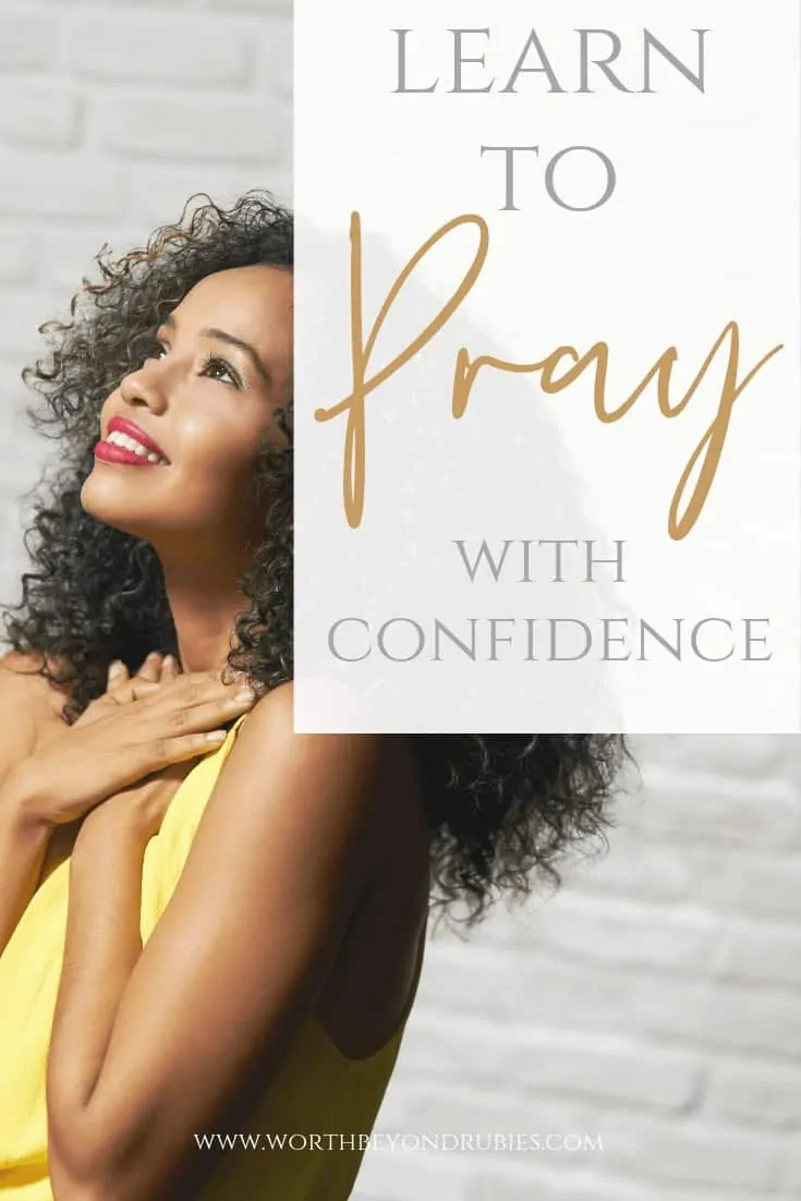 Pray with Confidence - ACTS Prayer Method - A woman with her arms across her chest looking up at the sky smiling with a white brick wall behind her