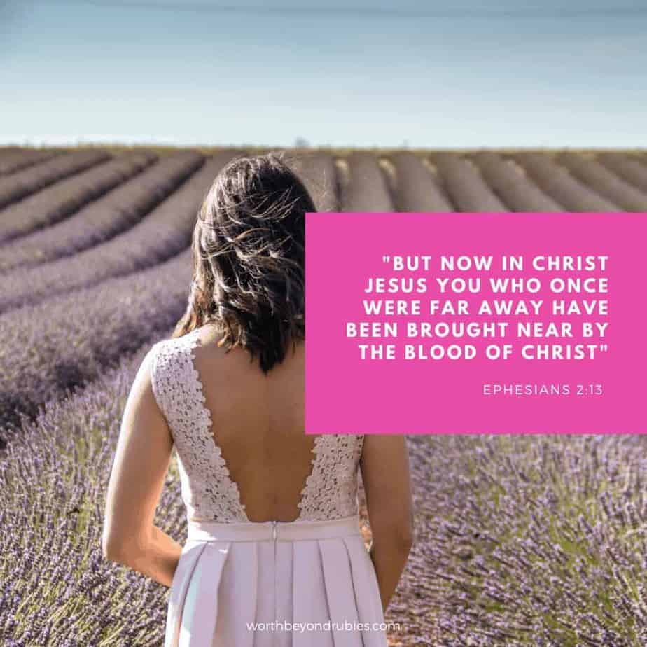 Grafted in Meaning - a woman in a pink dress facing away in a field of pink flowers with Ephesians 2:13 in text