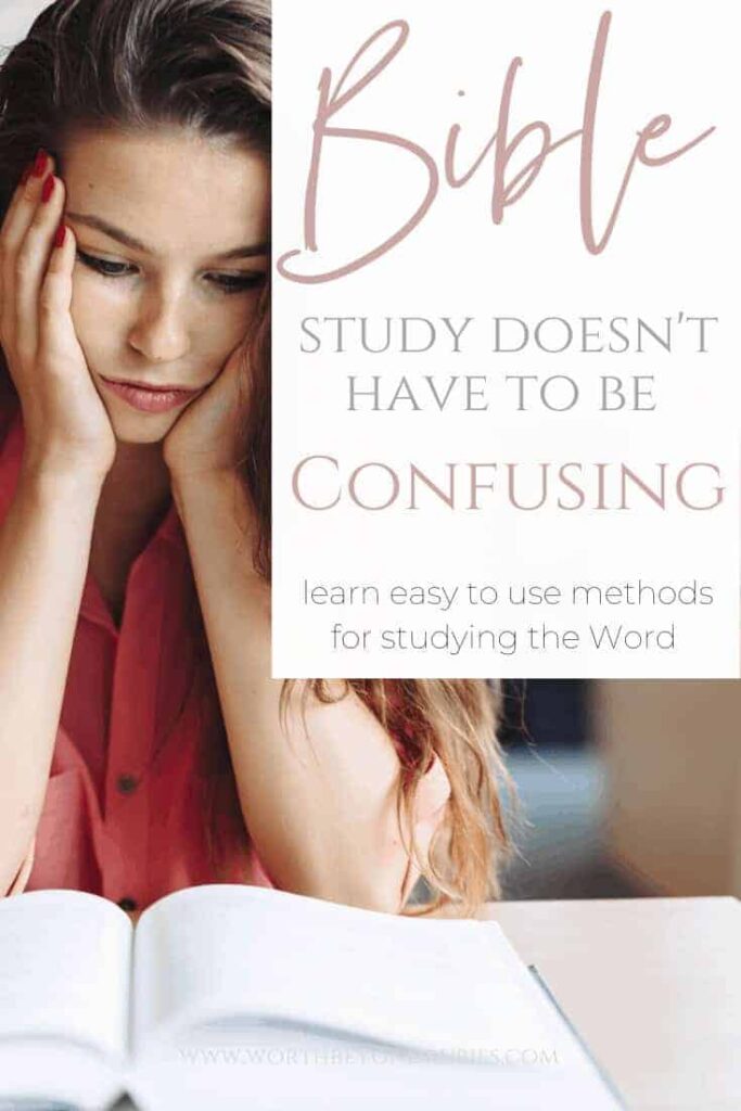 Bible Study Methods- a woman sitting at a desk reading a book with her head in her hands