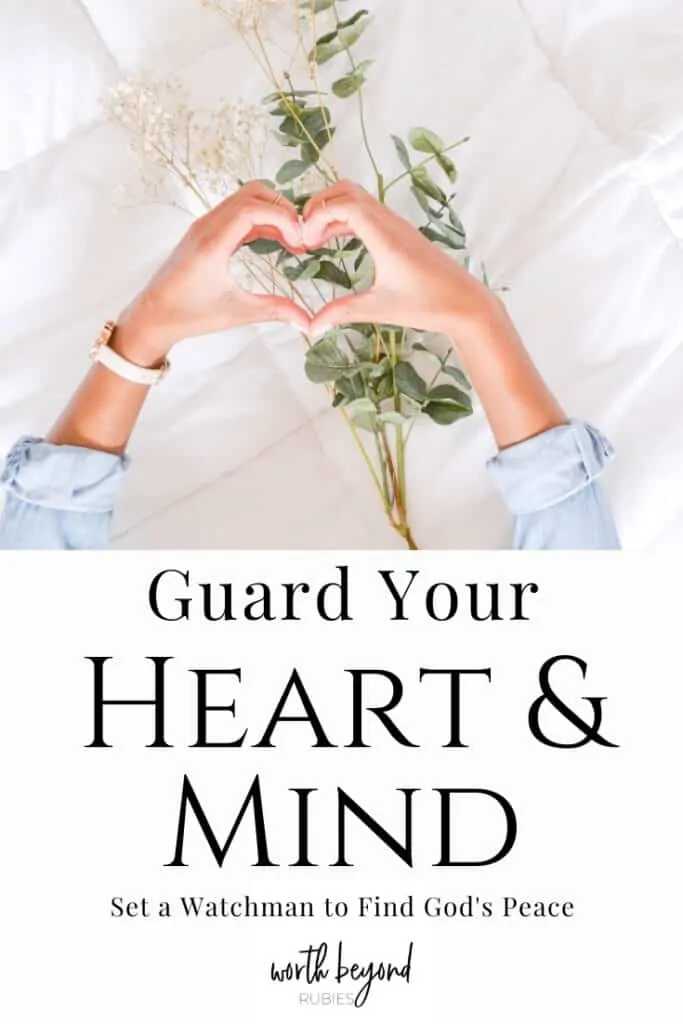 A woman's hands in the shape of a heart over a bed with a large sprig of baby's breath on it and a text overlay that says Guard Your Heart and Mind to Set a Watchman and Find God's Peace