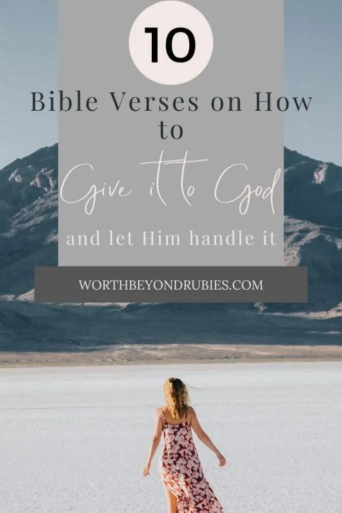 Give it to God - a woman in a sundress stands on the sand in front of a large mountain