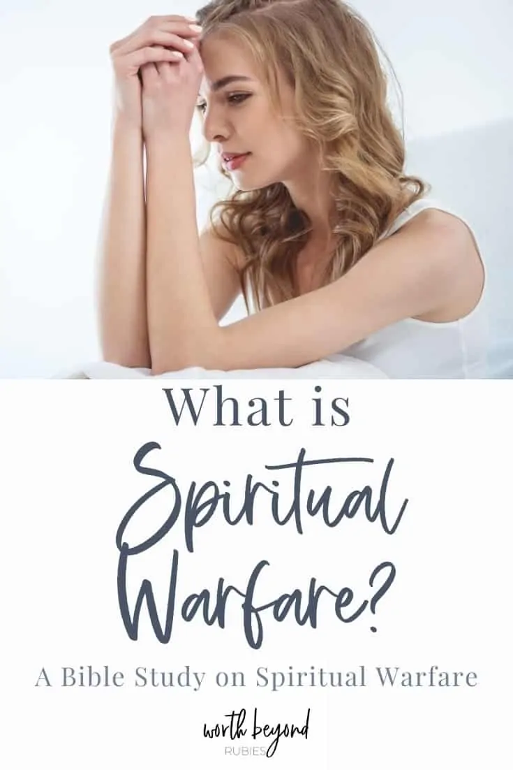 An image of a woman with long blonde hair in a white tank top with her elbows resting on a pillow and her hands folded up to her forehead, looking sad and text that says What is Spiritual Warfare - A Bible Study on Spiritual Warfare