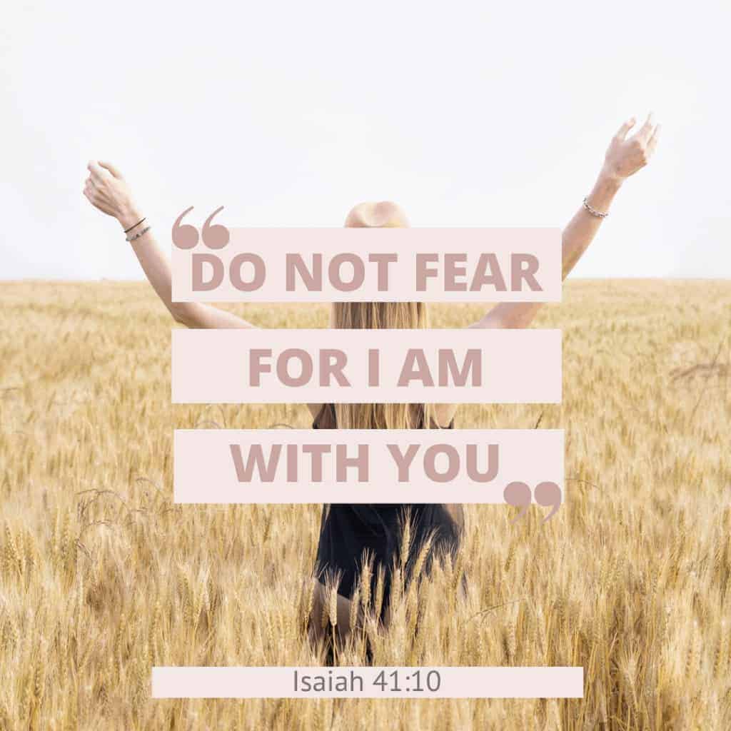 Isaiah 41:10 in quotes with an image of a woman in a wheat field wearing a hat with her arms stretched upward