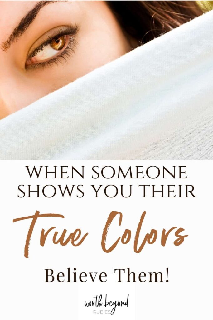 An image of a woman's face hidden behind a white veil with only one eye showing and text that says When Someone Shows You Their True Colors Believe Them