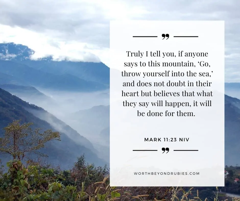 An image of a mountain range covered in mist and Mark 11:23 quoted