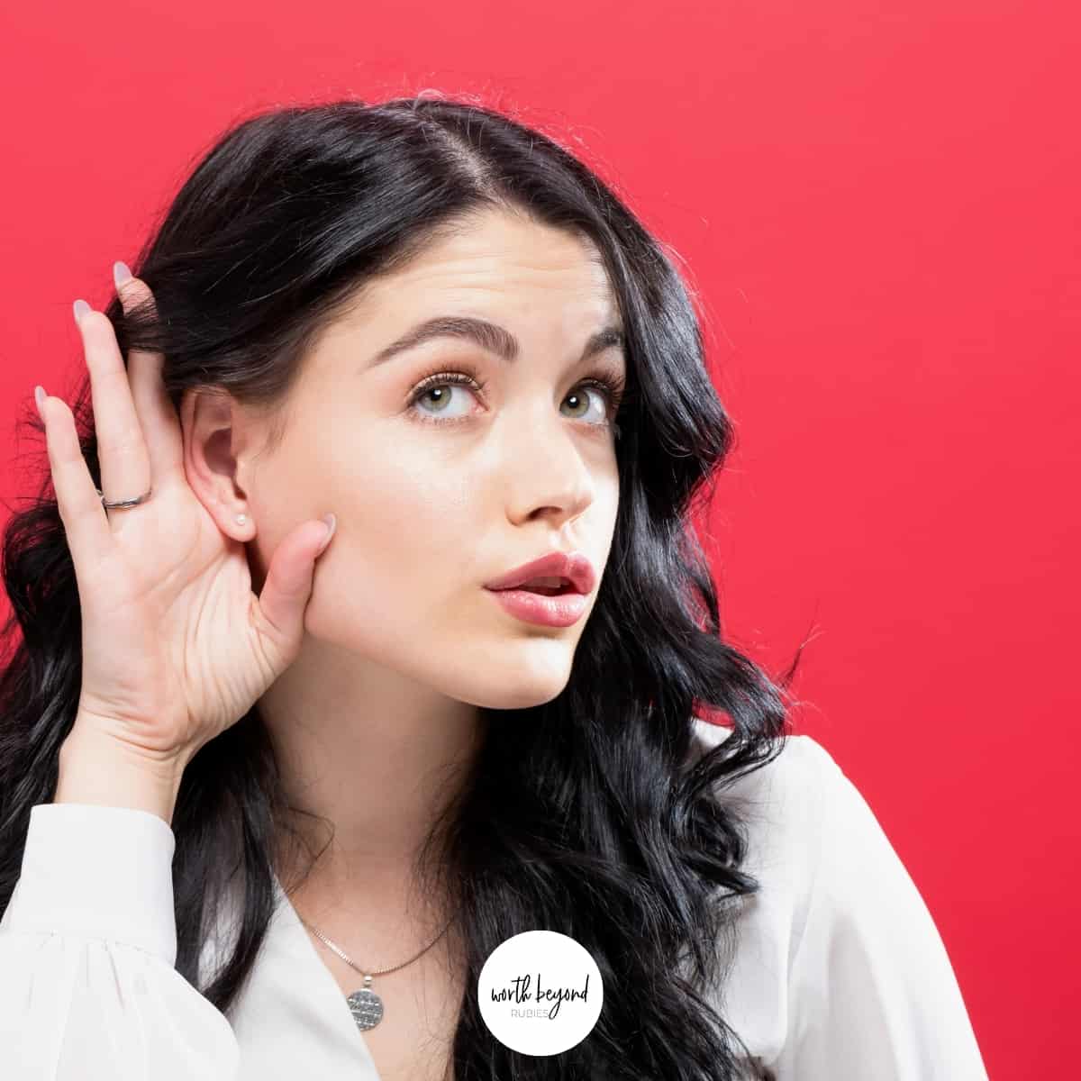 a woman with her hand up to her ear listening - for post called Prayer is Being in Conversation With God, So Why Aren't We Listening