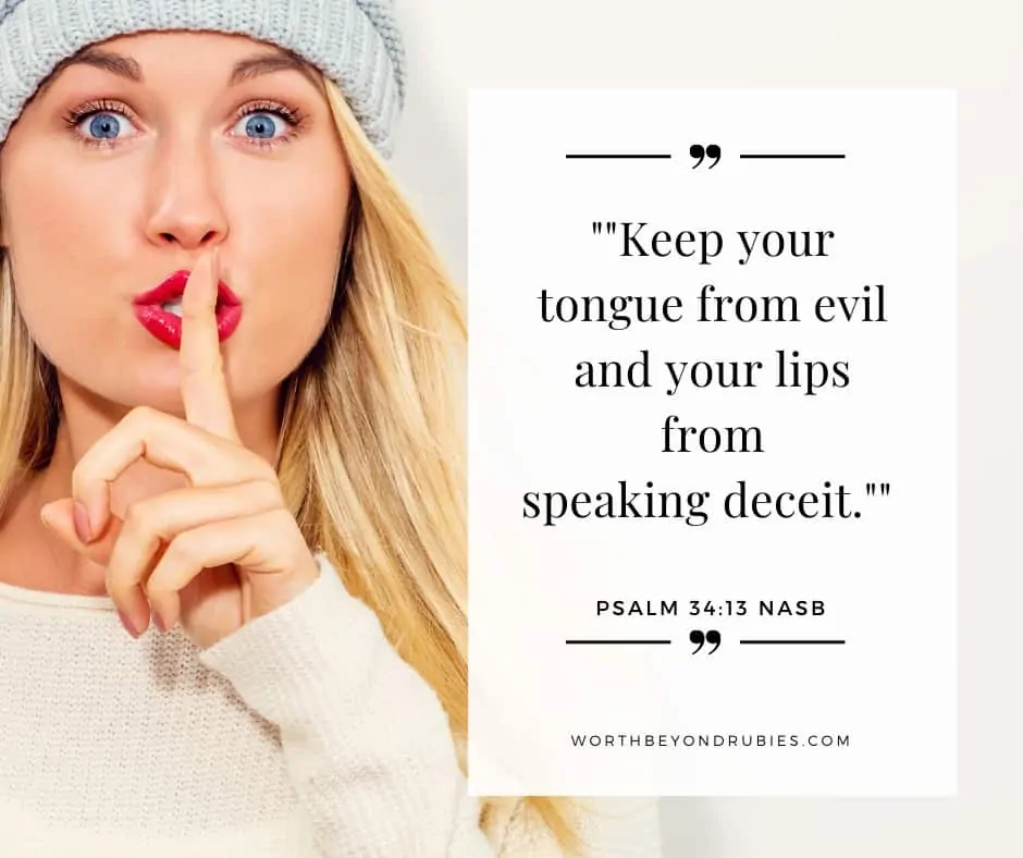 A woman with long blonde hair, red lips and a grey knit hat on with her finger up to her lips in a shh motion - What Does the Bible Say About Gossip?