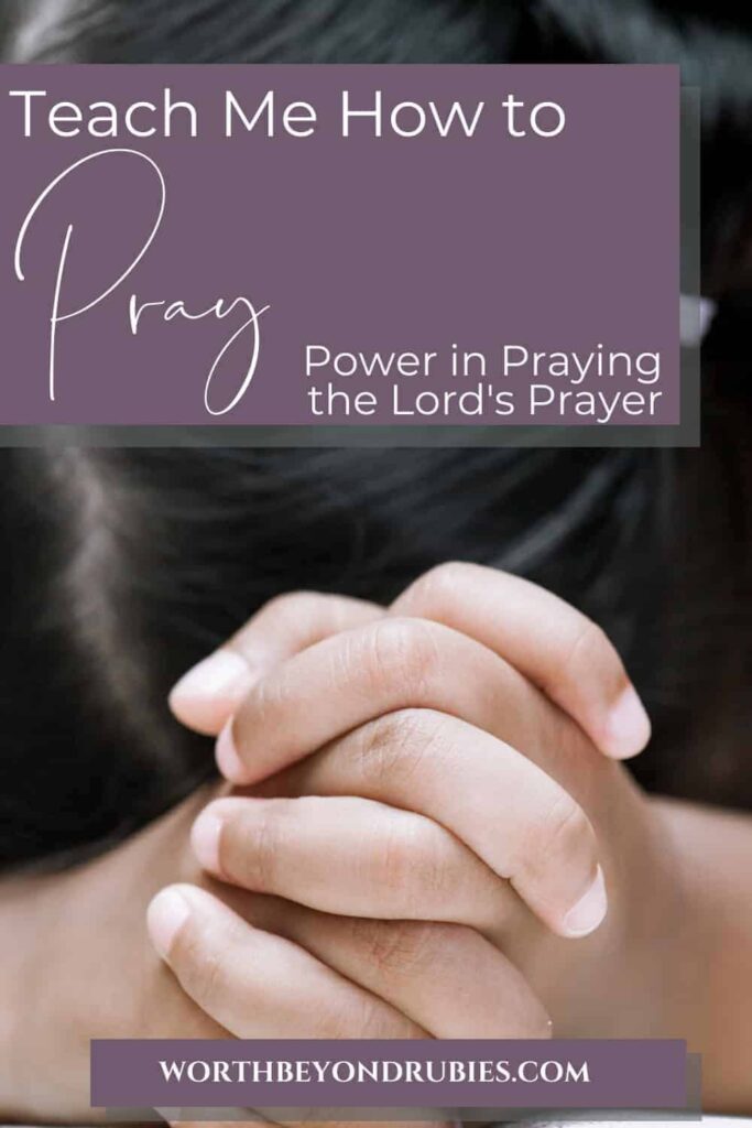 An image of a young girl with dark hair up in barrettes and her head down on a table with her hands folded in prayer and text that says Teach Me How to Pray - Power in Praying the Lord's Prayer