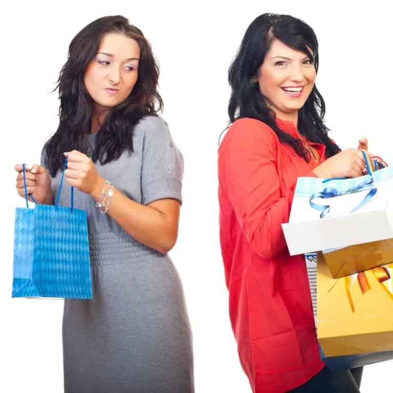 An envious woman holding a shopping bag looking at another woman holding many - What Does the Bible Say About Comparison - The Comparison Trap