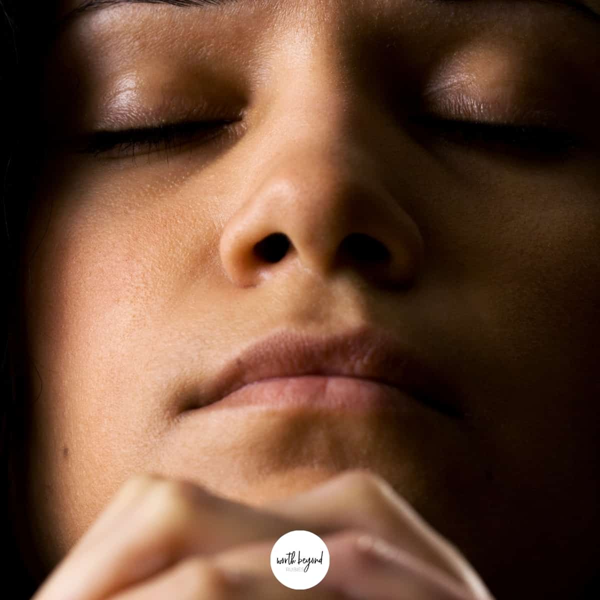 a woman with her eyes closed praying - for post called Finding Strength In God - Praying For Help During Trials