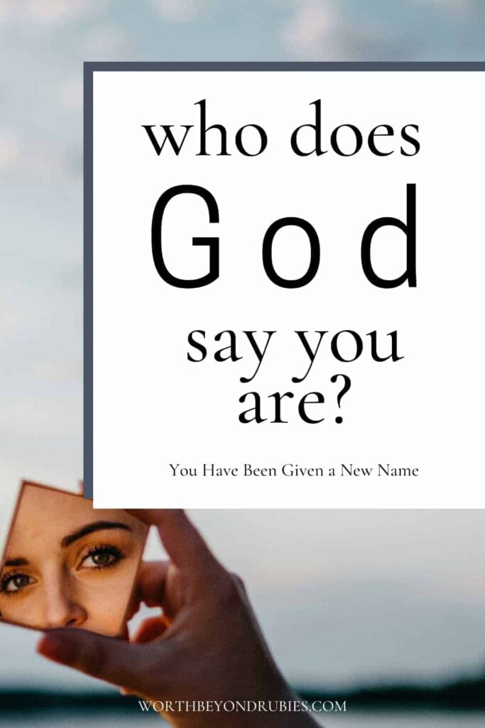 An image of a person's hand facing a lake at dusk with a mirror in their hand and a reflection of a woman's eyes and nose in the mirror and text that says Who God Says You Are - You Have a New Name