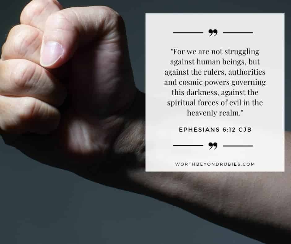 What Does it Mean to Be Holy and Blameless in the Bible? 4 Male clenched fist on grunge background with Ephesians 6:12 quoted in the Complete Jewish Bible version - Holy and Blameless