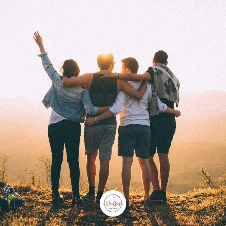 a group of people hugging on a hill
