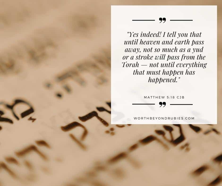 an image of Hebrew writing from a Torah scroll and a text overlay with Matthew 5:18 quoted from the CJB