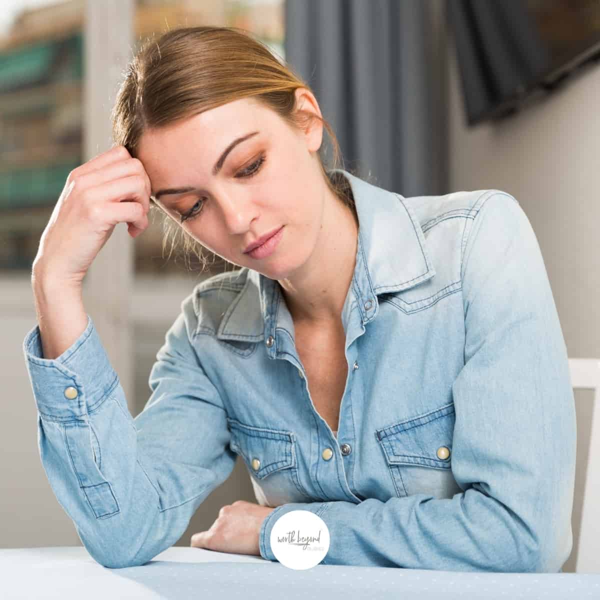Disappointed woman sitting at table - for post called Unmet Expectations - How to Manage Expectations Biblically