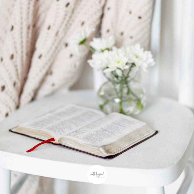 A bible open on a white chair with flowers on it for post Building a Relationship with God