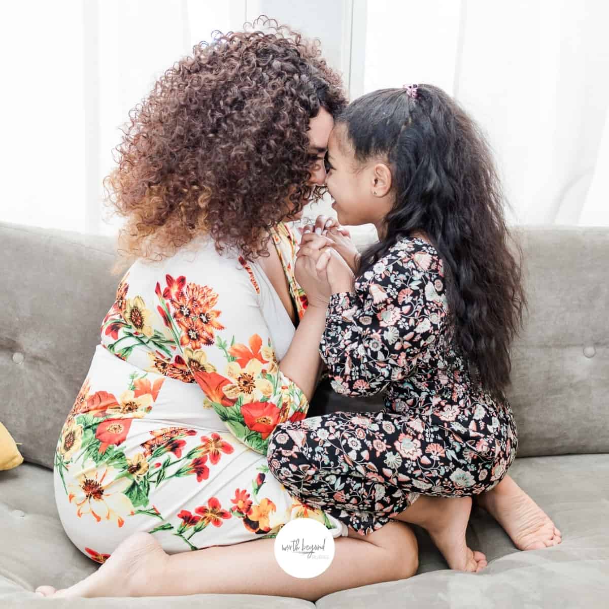 A woman and a child kneeling in front of eachother on a couch for post titled 20 Powerful Ways to Worship God Every Day