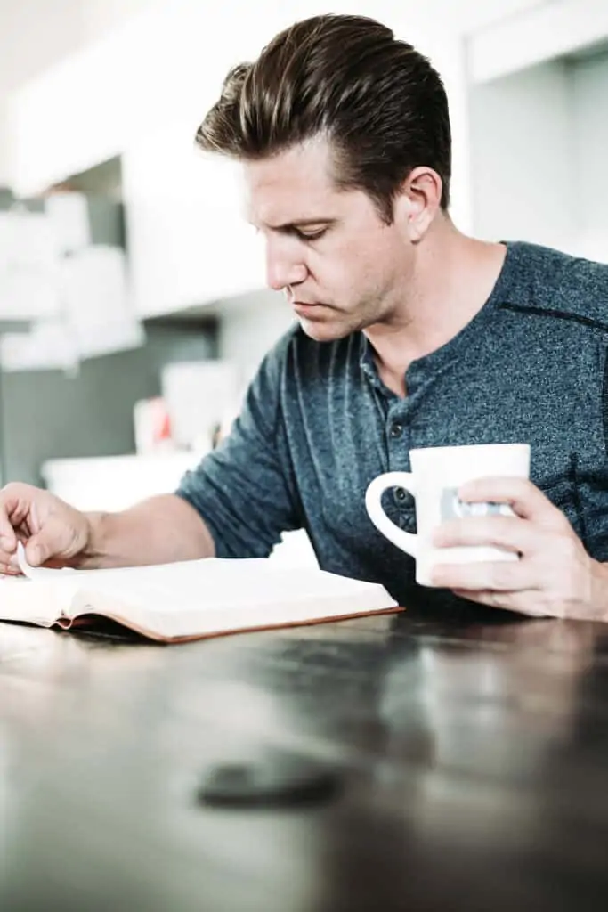 man with KJV Study Bible and a cup of coffee