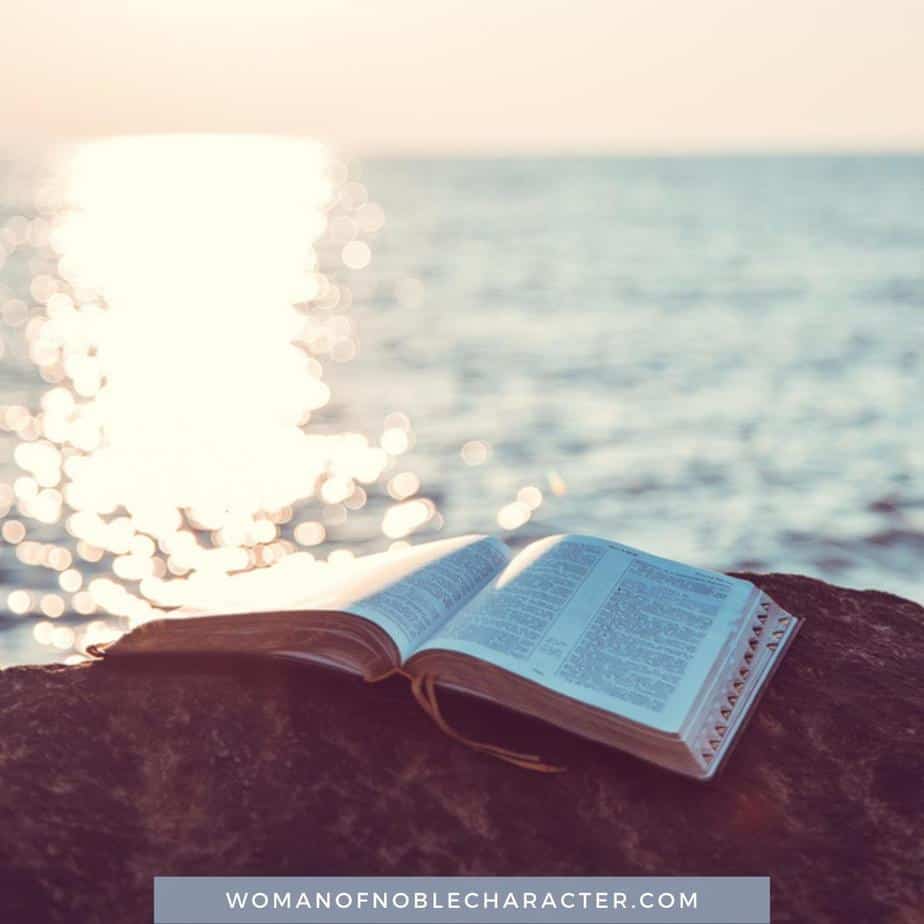 image of open Bible near shimmering water for the post The Fascinating Symbolism of Water in the Bible: 9 Attributes