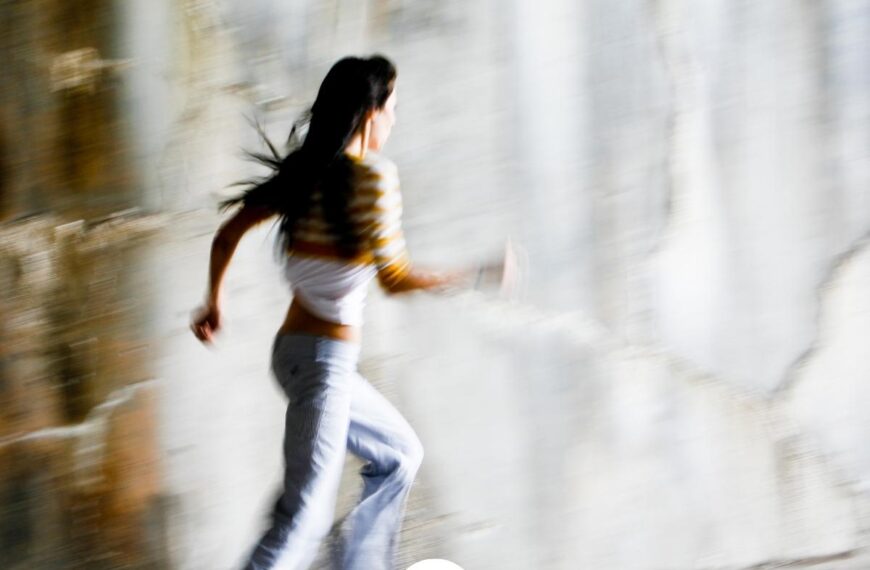 a woman running in a tunnel with the Worth Beyond Rubies logo at the bottom of the image for post called How to Stop Running From God