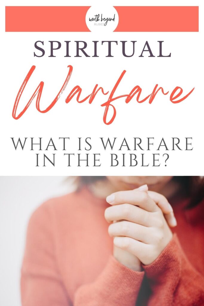 A woman's torso in an orange sweater and her hands in front folded in prayer and a text overlay that says Spiritual Warfare - What is Warfare in the Bible?