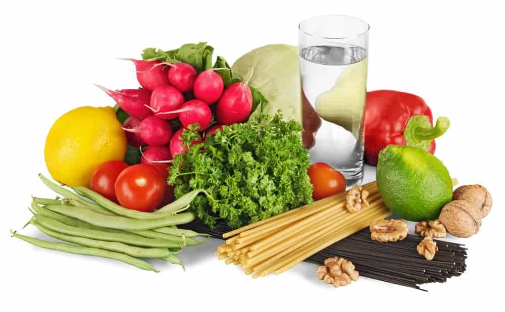 What is a Daniel Fast, Its Benefits, and How to Do It 4 vegetables with glass of water for the post on the Daniel Fast