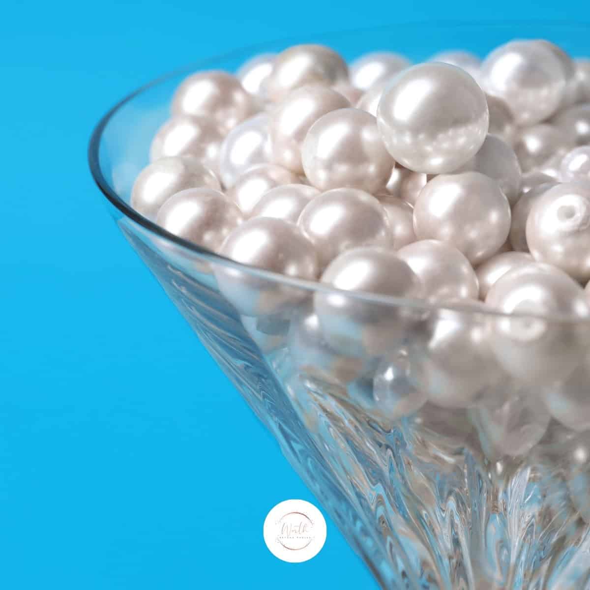a glass with pearls in it