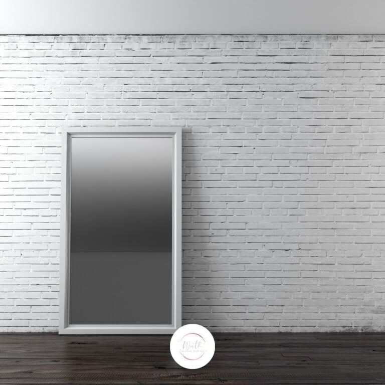 a mirror leaning against a brick wall
